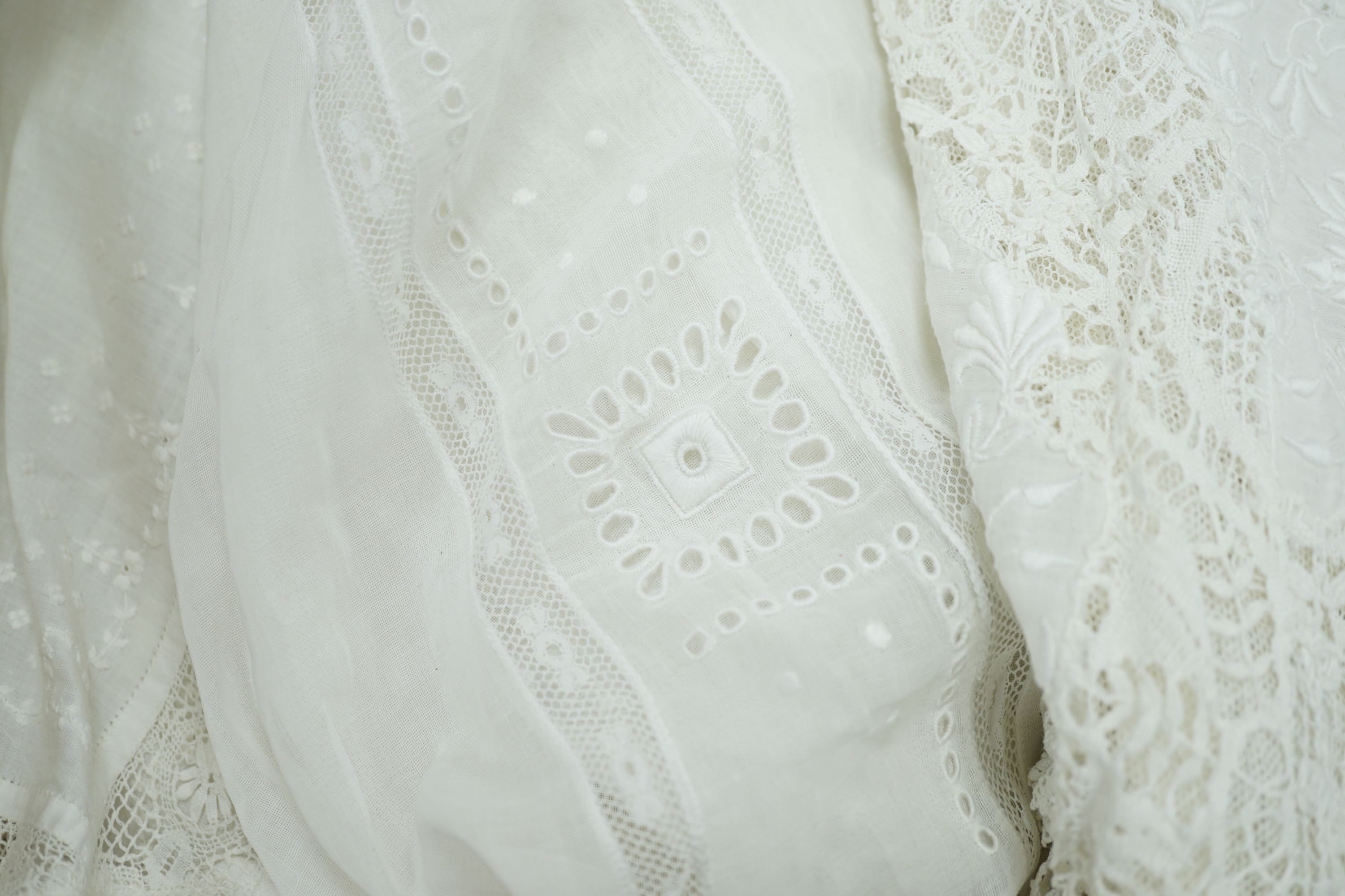 A 19th century hand made Irish crochet jacket, with long sleeves and high collar, a bobbin lace and white worked patch worked blouse, a fine lawn and anglaise worked blouse and a fine bobbin lace trimmed and white worked